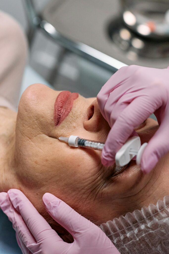 Older woman receiving an injection near her lips